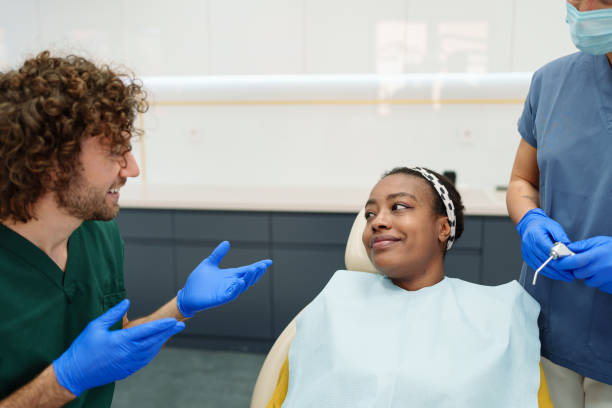 istock Dentist Consults with Smiling Patient in Modern Clinic 2195721417