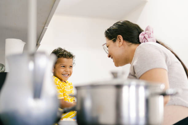 istock Latin mother and son sharing a happy moment while cooking together 2195721446