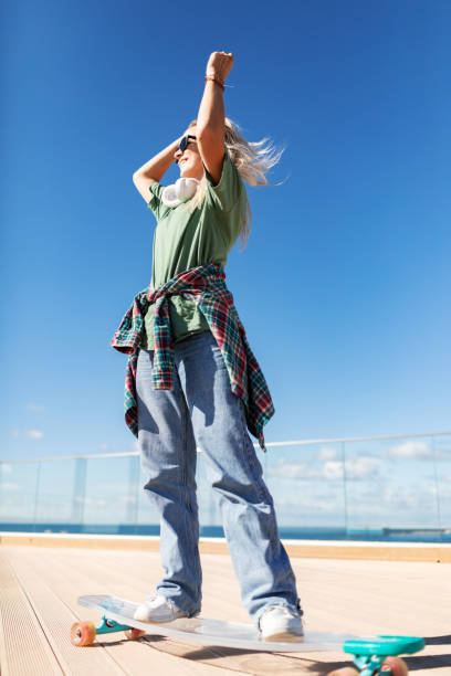 istock Mid adult woman skateboarding 2195721577