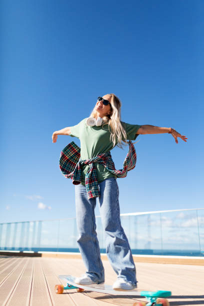 istock Mid adult woman skateboarding 2195721902