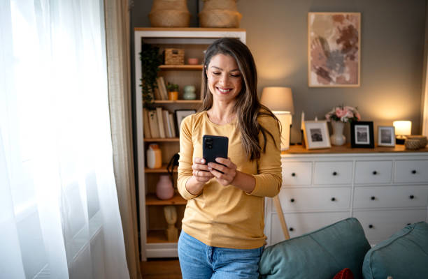 istock Young woman using phone at home 2195722569