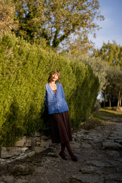 istock Woman Relaxing by Hedge in Sunshine 2195723324