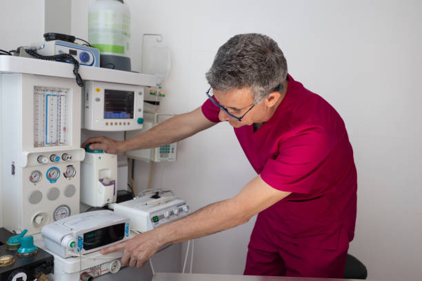 istock Veterinarian adjusting controls of anesthesia machine in preparation for operation in veterinary clinic 2195724176
