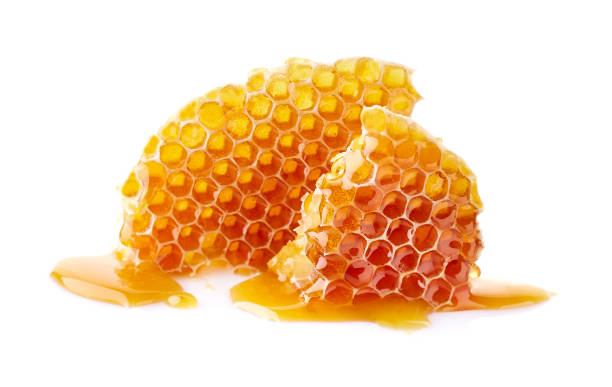 istock Honeycomb with honey drop on white background 2195724238