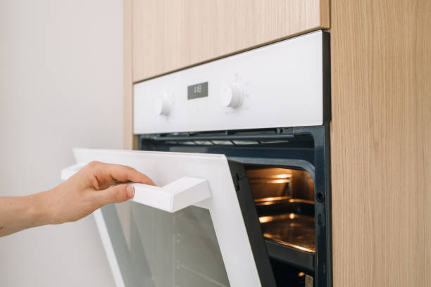 istock Modern kitchen with an oven door being opened in a minimalist apartment space 2195724705