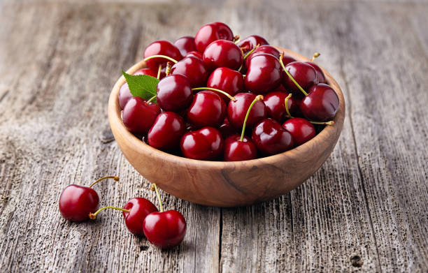 istock Sweet cherry on wooden background 2195724826