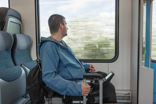 istock Traveler with a physical disability enjoying train journey, looking out the window 2195725010