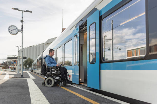 istock Man with a physical disability, an electric wheelchair user entering a train 2195725021