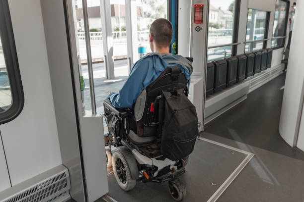 istock Man with a physical disability, an electric wheelchair user exit a train 2195725093