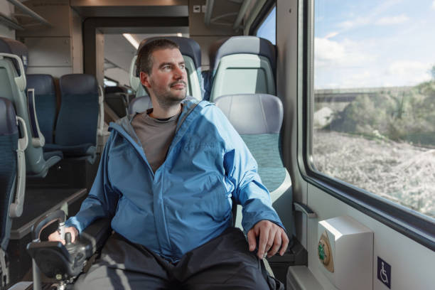 istock Traveler with a physical disability enjoying train journey, looking out the window 2195725113