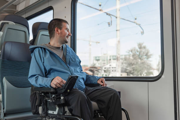 istock Traveler with a physical disability enjoying train journey, looking out the window 2195725121