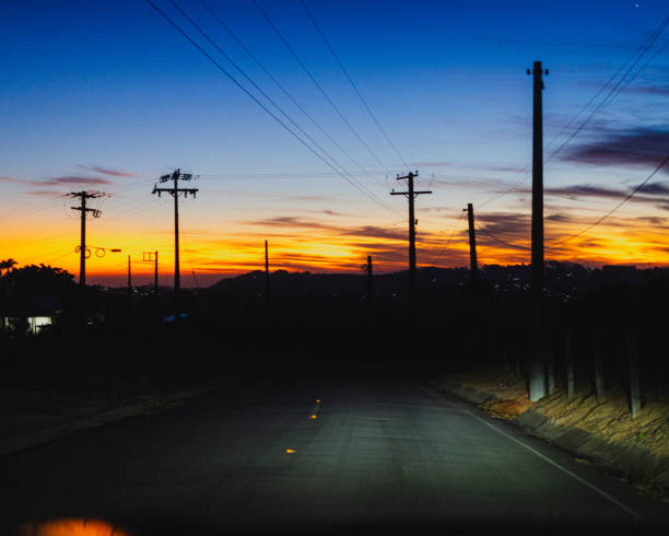 istock Rural Road at Sunset with Power Lines 2195728648
