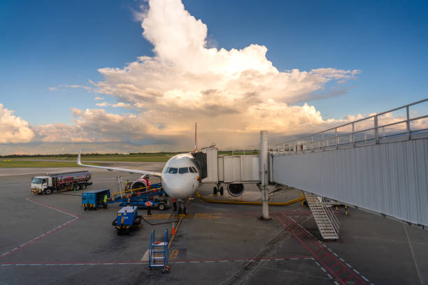 Avianca plane at Palmira airport with the boarding bridge connected at sunset on a sunny day. Colombia. Avianca plane refueling in the boarding area of Alfonso Bonilla Aragón International Airport. Valle del Cauca. Colombia. November 24, 2024. palmira colombia stock pictures, royalty-free photos & images