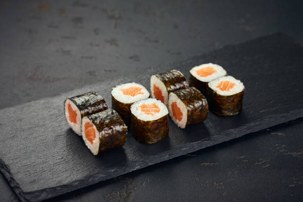 istock Roll with salmon on dark background. Sushi menu. Japanese food. 2195729423