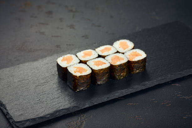 istock Roll with salmon on dark background. Sushi menu. Japanese food. 2195729427