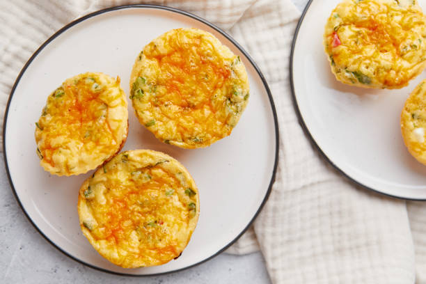 istock Savory muffins with egg, feta cheese, cheddar and spinach on light background 2195729481
