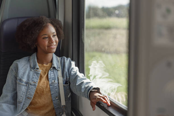 istock Passenger sitting on window seat, looking at a landscape from the moving vehicle 2195735647