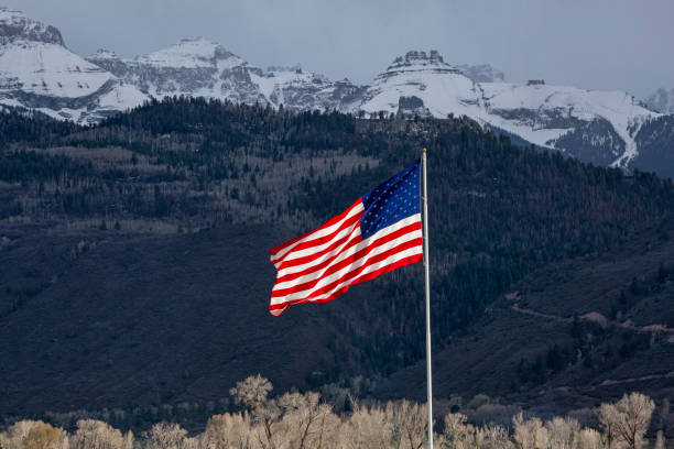 An oversized American flag waves in the breeze in the mountains of Southwest Colorado.