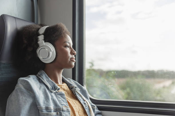 istock Young woman traveling by train, enjoying her trip while looking through the window 2195737209