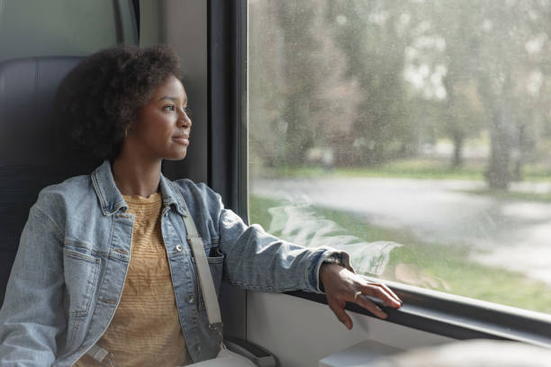 istock Passenger sitting on window seat, looking at a landscape from the moving vehicle 2195737256