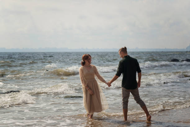 istock lovers and romantic newlyweds having fun on the seashore. 2195738397