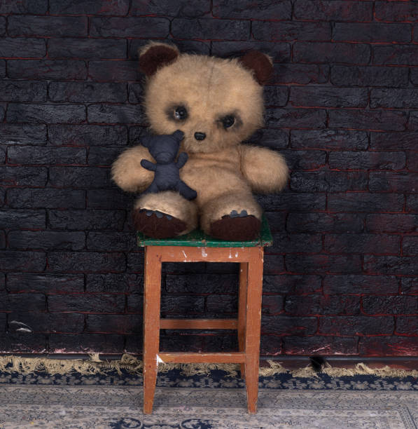 istock old dirty teddy bear on a chair 2195738796