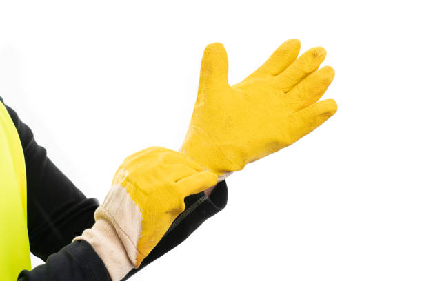 istock Close-up of male constructor putting on industrial work gloves 2195738856