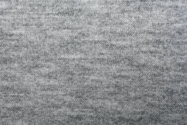 Close up, macro of gray woven fabric with detailed texture and diagonal pattern. Textile, cloth, material,  fashion, upholstery, or abstract design background.