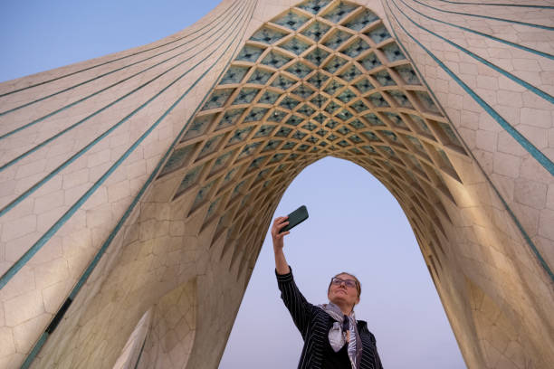 Tourist taking selfie at azadi tower in tehran, iran