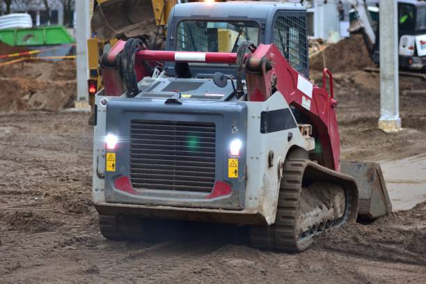 istock Mini caterpillar excavator digging and pushing ground in big construction site 2195747273