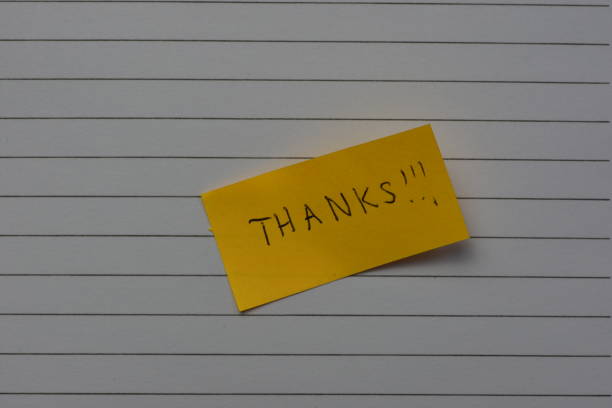 istock Message thanks thank you on yellow sticky note day on notebook line paper background 2195748780