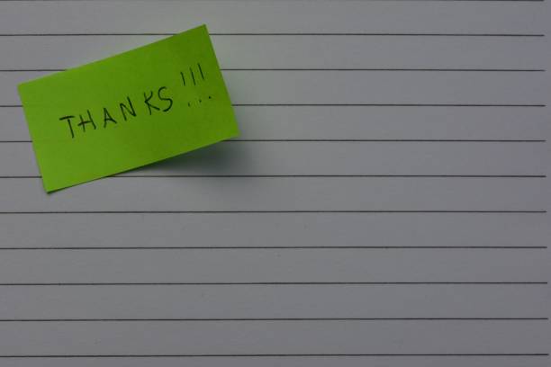 istock Message thanks thank you on green sticky note day on notebook line paper background 2195748784
