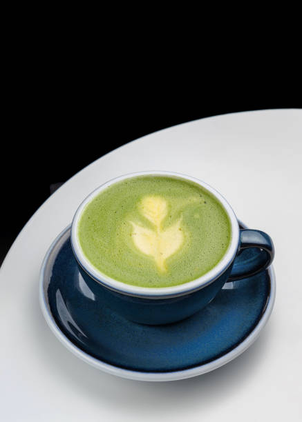 cup with fresh green matcha orange drink. Citrus matcha. Cafe restaurant menu. Black background, place for text. Copy space