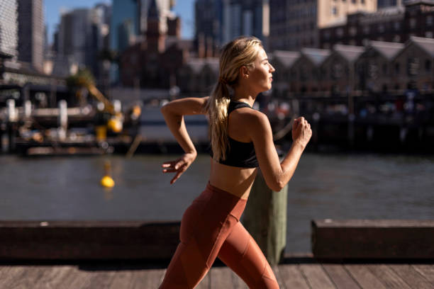 istock Fit woman jogging on pier 2195751826