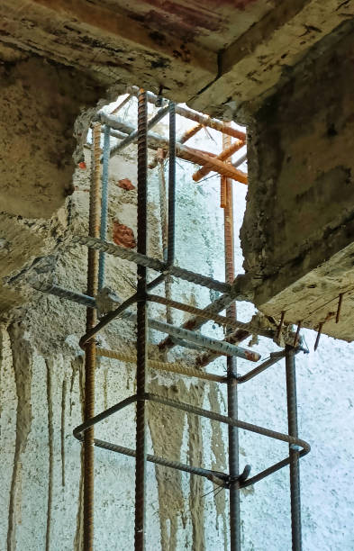 istock Renovators are working on a building interior, showcasing scaffolding and exposed materials near a large opening in the wall 2195754354