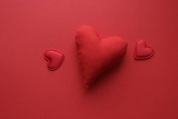 Valentine's Day background. Red heart on a red background.