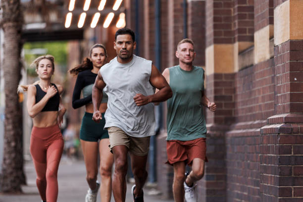 istock Group of friends running together 2195756026