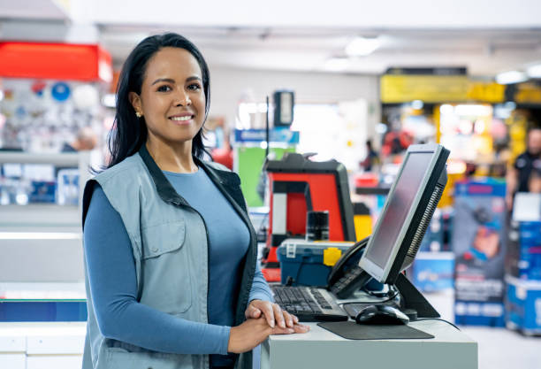 istock Happy cashier working at a hardware store and smiling 2195758843