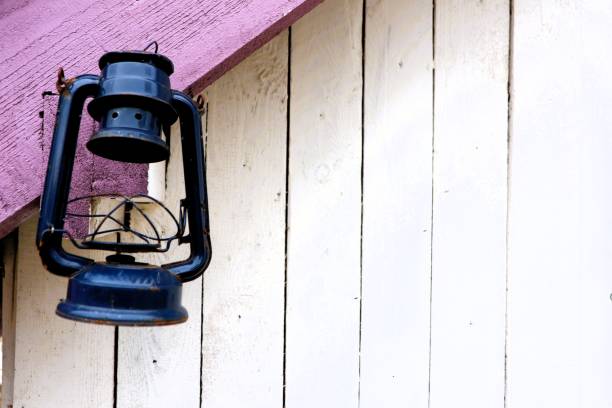 istock A Vintage Black Lantern Hangs Beautifully on a Rustic Wooden Wall Surrounded by History 2195771615