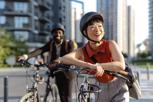 istock Two friends enjoying a bike ride in a modern urban setting 2195772934