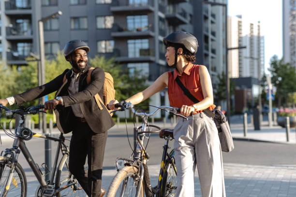 istock Two colleagues with bicycles in a cityscape sharing a cheerful conversation 2195772949