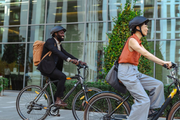 istock Two professionals riding bikes in an urban setting 2195773168