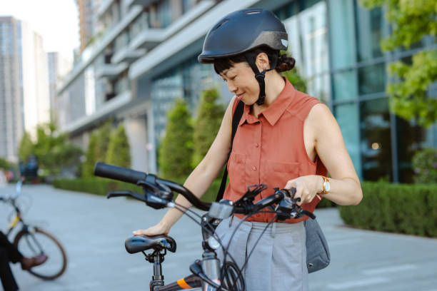 istock Smiling Japanese female commuter with her bicycle 2195773305