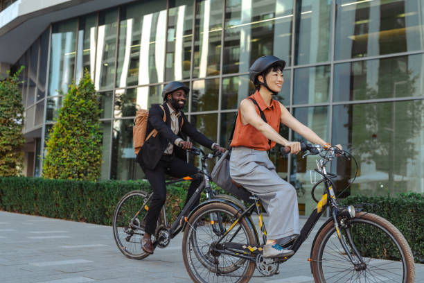 istock Two colleagues biking to work enjoy a sunny morning commute 2195773307
