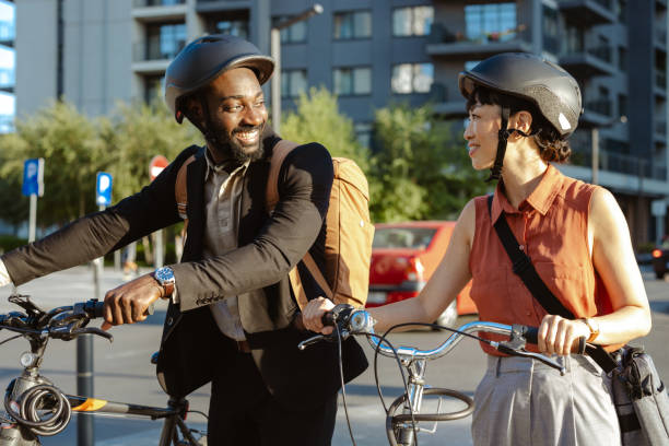 istock Two colleagues with bicycles in a cityscape sharing a cheerful conversation 2195773368