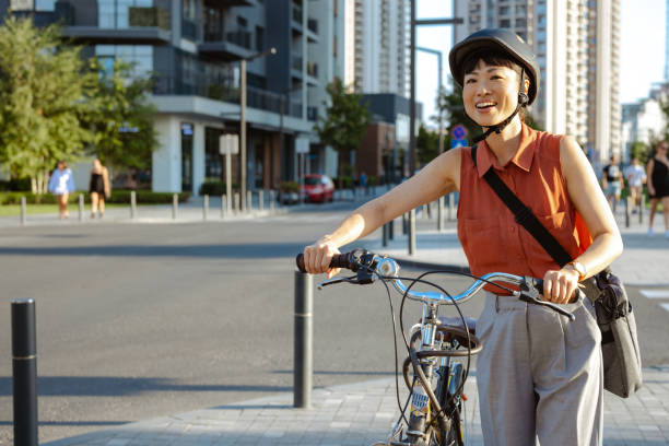 istock Smiling Japanese female commuter with her bicycle 2195773374