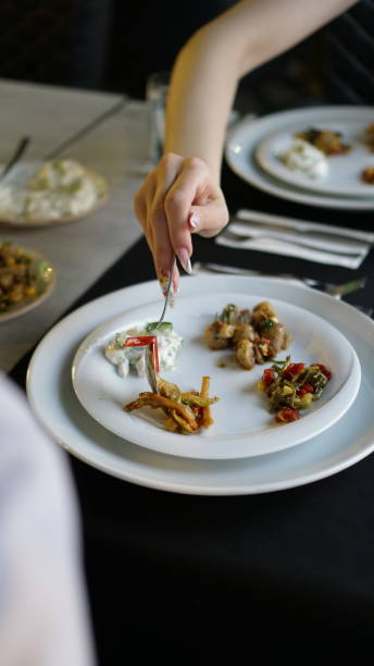istock woman hand filling appetizers 2195774551