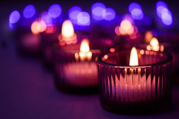 istock Candlelight Glow. Candles flickering in glass holders 2195776208