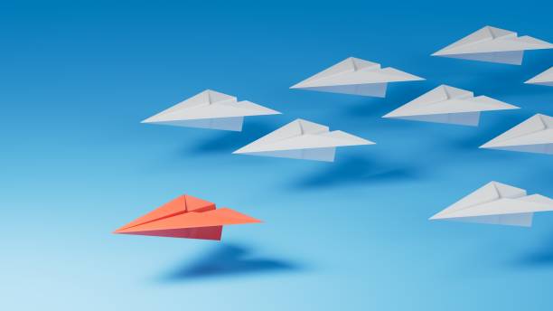 istock Leaderplane concept. Red leader paper plane leading among white on blue background. copy space.3D rendering on blue background. 2195777287