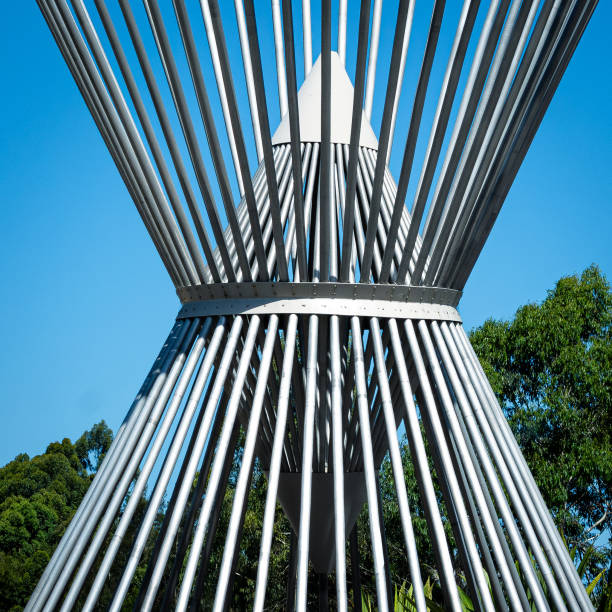 istock Close up of steel double cone shape against blue sky background 2195778634